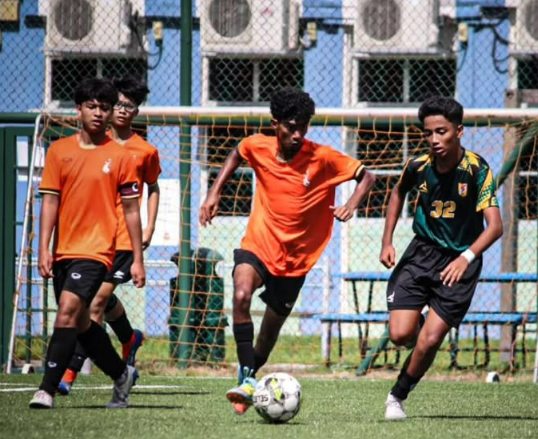 CCKSS football team in action during a competitive school football match.
